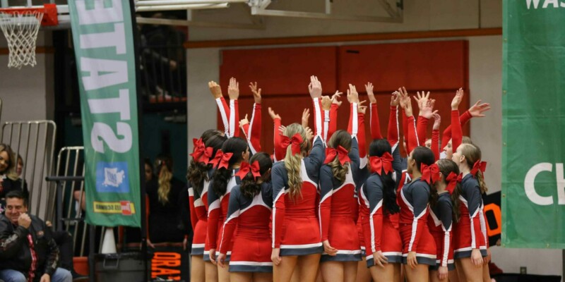Cheerleading Squad with Hands Raised