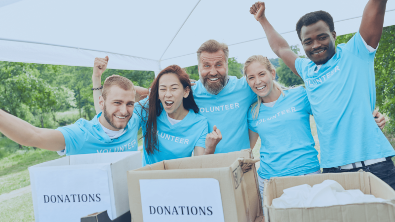volunteers with arms raised